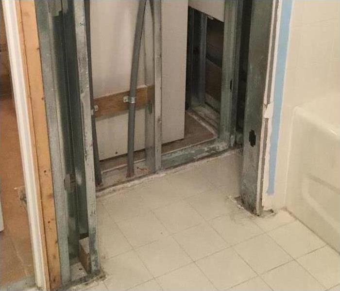 Bathroom closet with all drywall removed