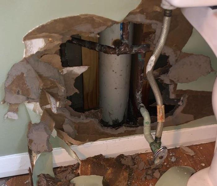 broken bathroom wall due to busted pipe