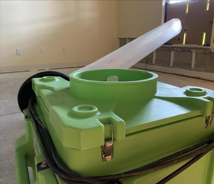 Green air scrubber ducted into a plastic barrier